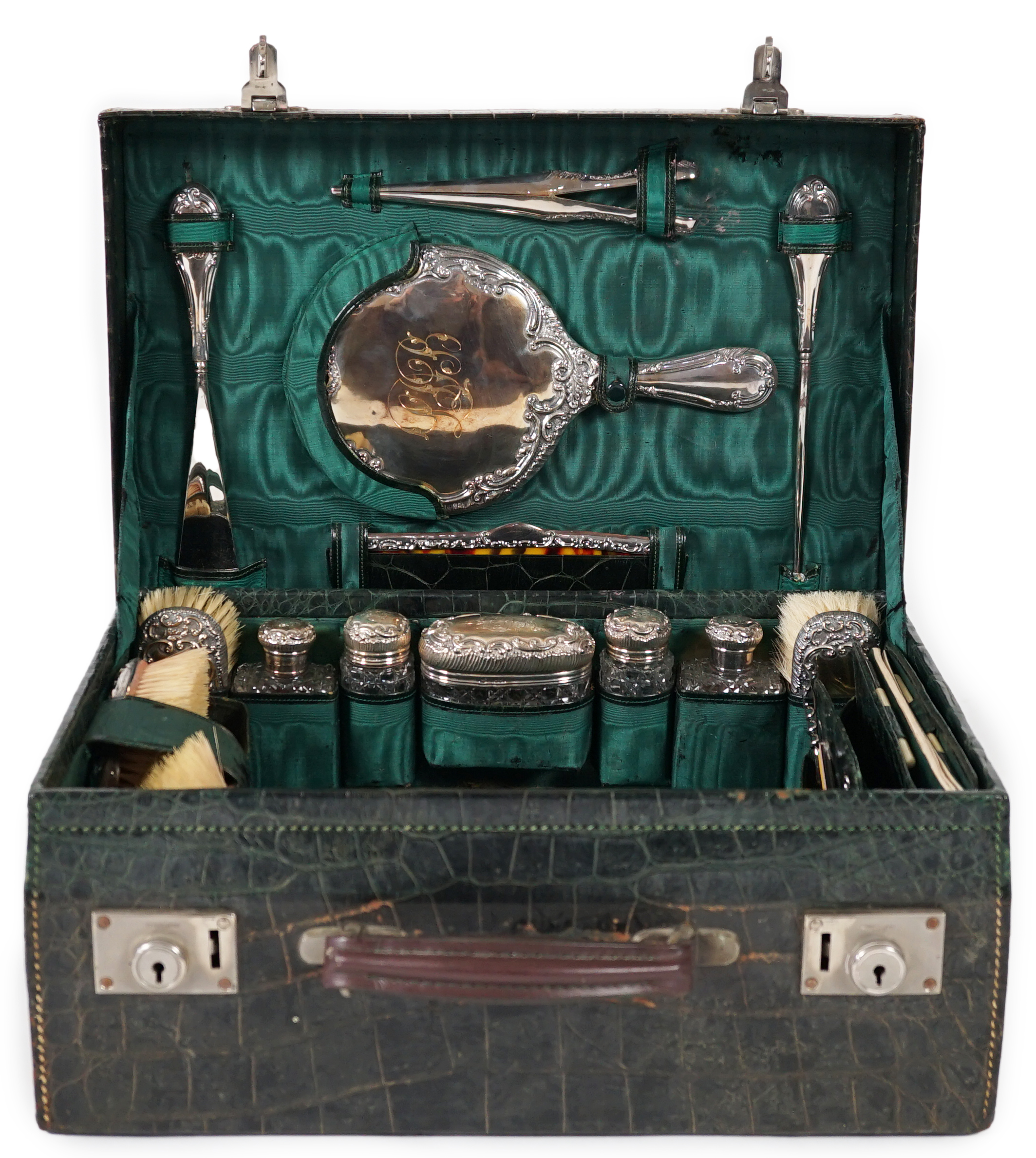 A George V green crocodile toilet case, 46cm x 33cm x 18cm